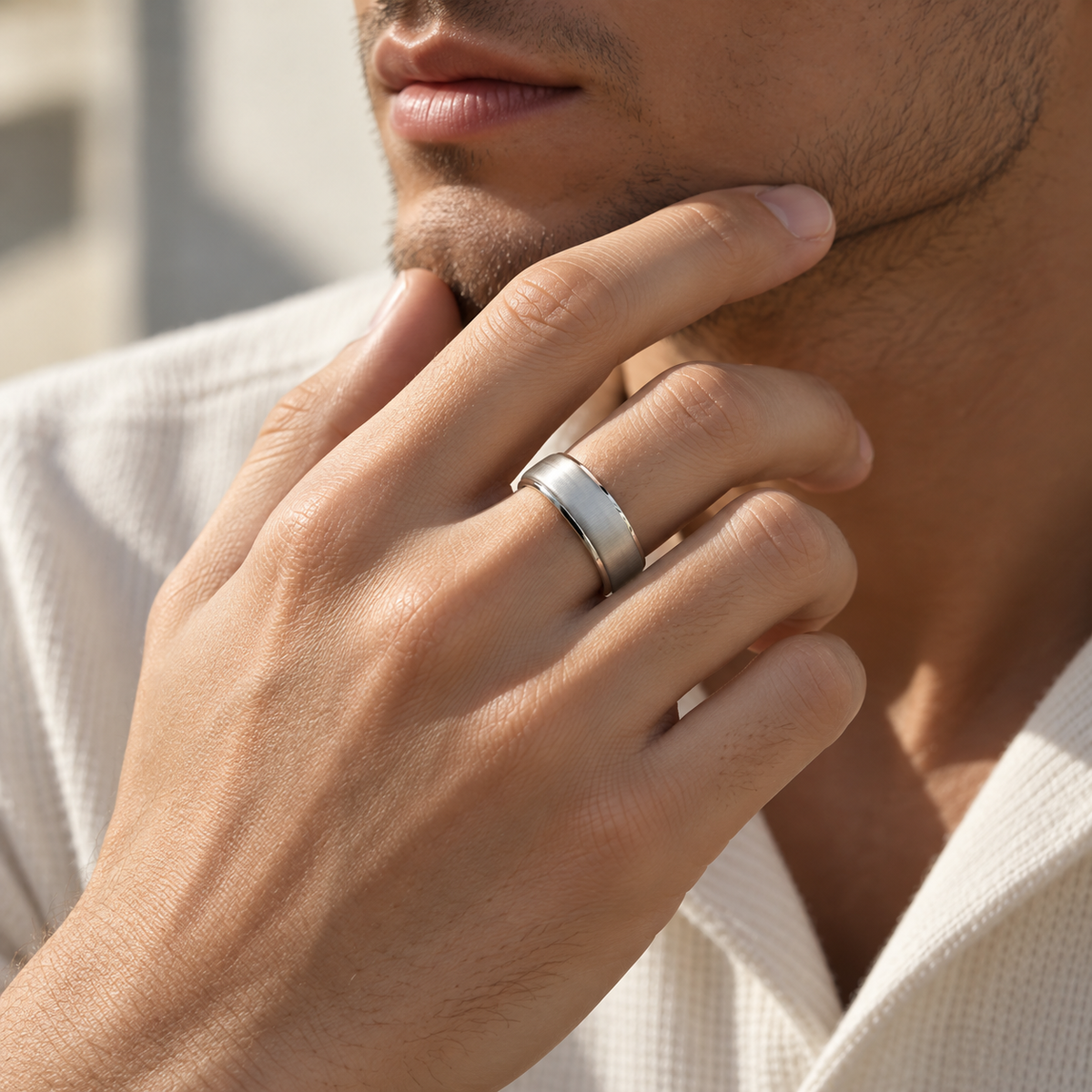 Man wearing a silver SY15 smart ring with a brushed finish, resting his hand against his chin