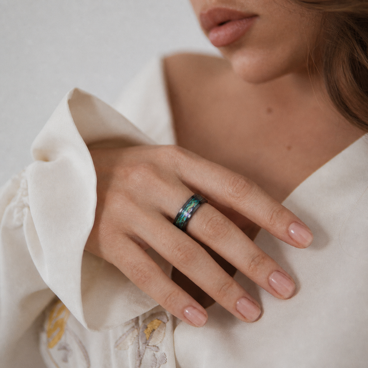 Close-up of Wrongduck Nebula smart ring worn with ivory clothing#color_nebula