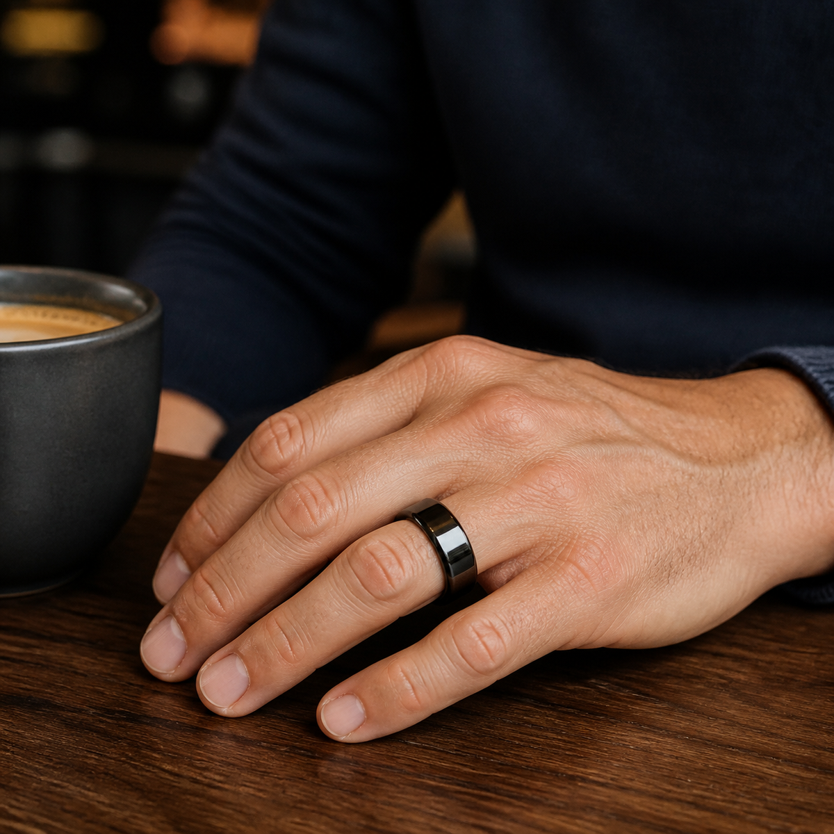Man wearing a glossy black SR1 smart ring at a cafe#color_sr1-black