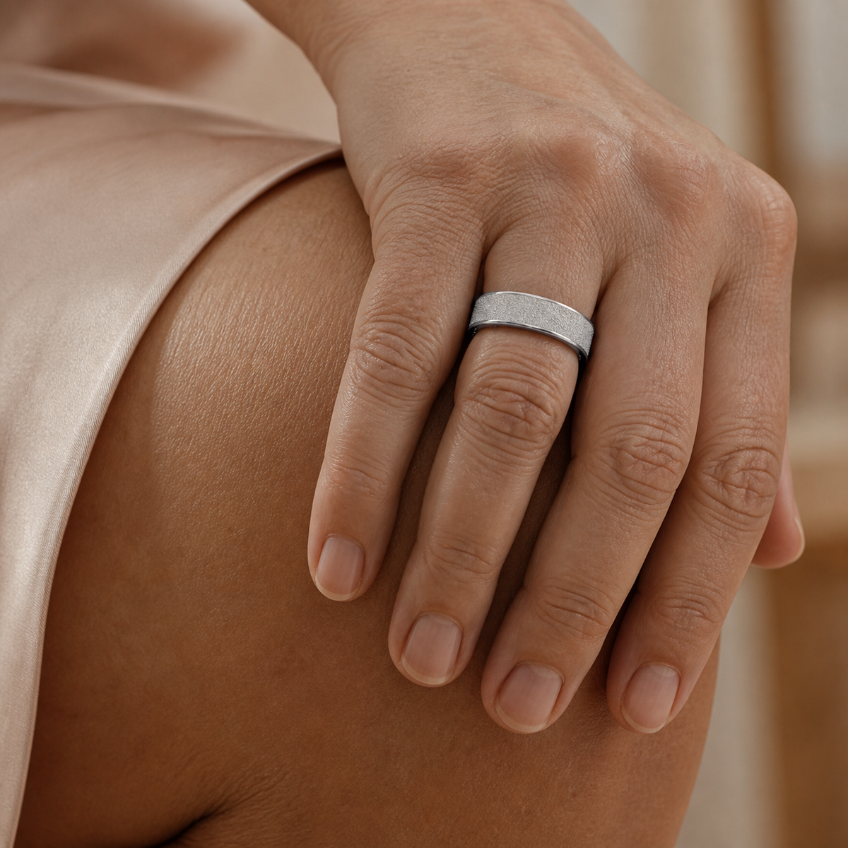 Silver V3 matte smart ring worn on a hand with a soft neutral background