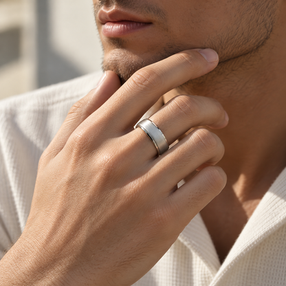 Man wearing a silver SY15 smart ring with a brushed finish, resting his hand against his chin