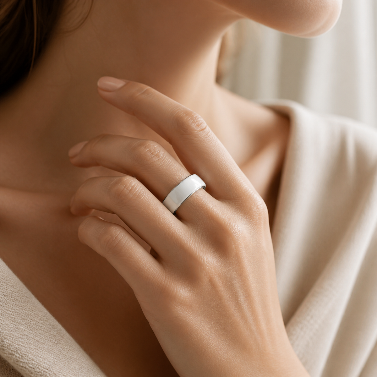 White ceramic smart ring worn by a woman