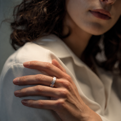 Woman wearing a Retro White Smart Ring with gold detailing in a soft indoor portrait setting