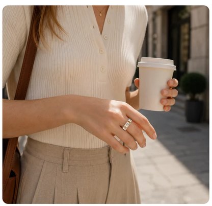 Woman wearing Butterfly Floral smart ring while holding a coffee