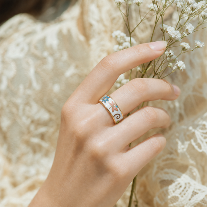 Woman wearing the Wrongduck Butterfly Floral smart ring while holding delicate white flowers
