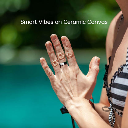 Woman wearing black and white ceramic smart ring by pool under Smart Vibes on Ceramic Canvas text