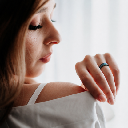 Woman wearing Wrongduck Nebula smart ring by a softly lit window#color_nebula