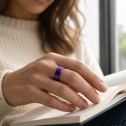 Woman wearing a polished purple smart ring while reading by a window#color_purple
